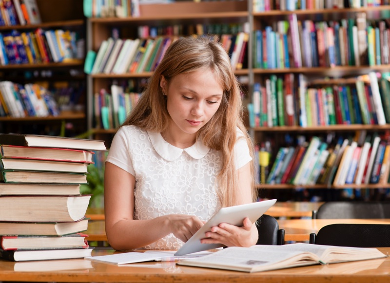 Girl reading tablet library resized
